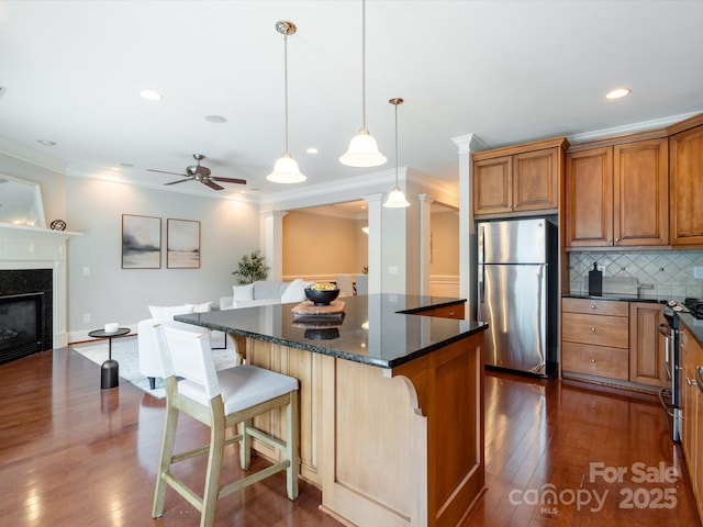 705 Congressional Ln, Fort Mill, SC 29708 - kitchen with stainless steel appliances, dark wood-type flooring, brown cabinets, a breakfast bar area, and a center island