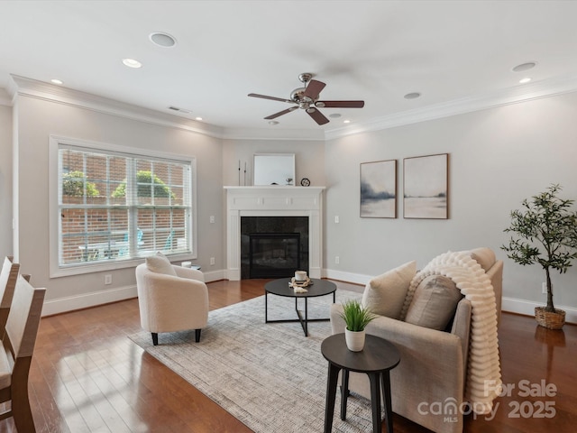 705 Congressional Ln, Fort Mill, SC 29708 - living room featuring a ceiling fan, a glass covered fireplace, wood finished floors, ornamental molding, and baseboards