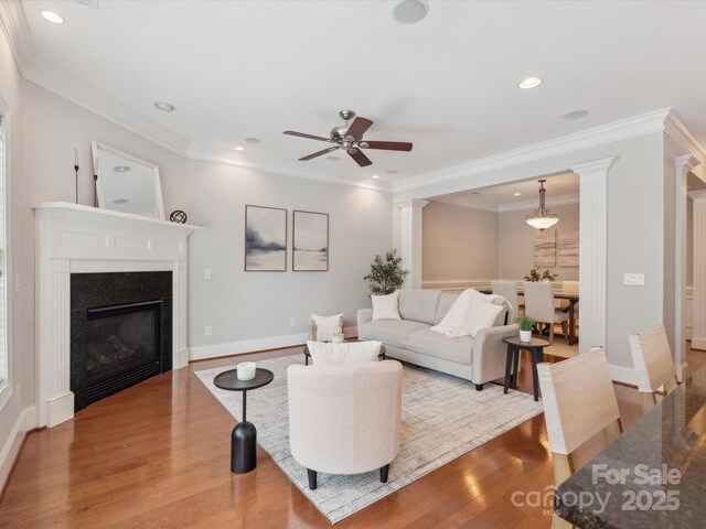 705 Congressional Ln, Fort Mill, SC 29708 - living area featuring wood finished floors, ceiling fan, a glass covered fireplace, recessed lighting, and ornamental molding