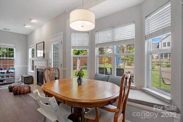 4797 Chesney St NW, Concord, NC 28027 - dining room featuring a glass covered fireplace and wood finished floors