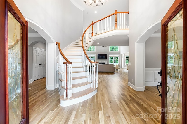 3324 Greenhurst Dr, Weddington, NC 28104 - foyer with arched walkways, a high ceiling, wood finished floors, stairs, and a chandelier