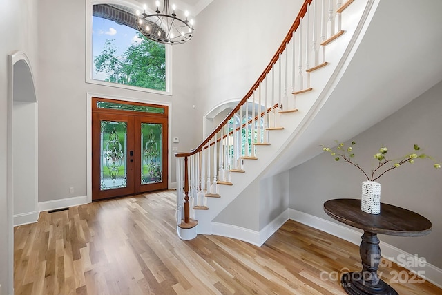 3324 Greenhurst Dr, Weddington, NC 28104 - entryway with a towering ceiling, a chandelier, stairs, and wood finished floors