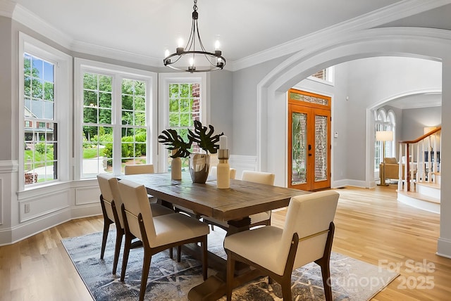 3324 Greenhurst Dr, Weddington, NC 28104 - dining room with arched walkways, a chandelier, plenty of natural light, light wood-type flooring, and ornamental molding