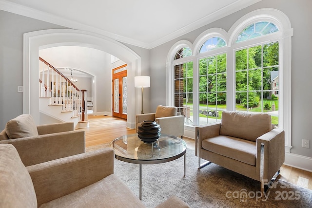 3324 Greenhurst Dr, Weddington, NC 28104 - living room with stairway, wood finished floors, healthy amount of natural light, arched walkways, and crown molding