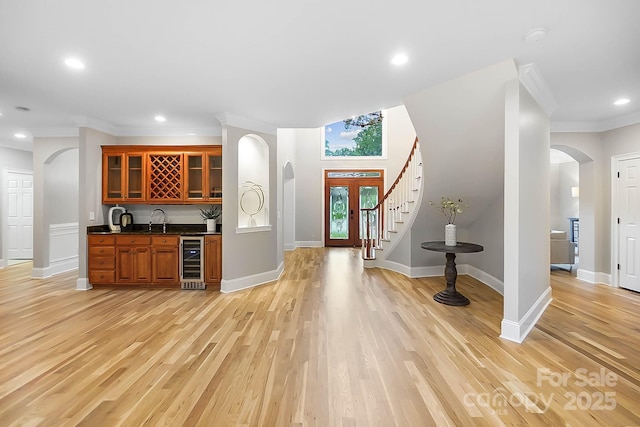 3324 Greenhurst Dr, Weddington, NC 28104 - kitchen with beverage cooler, arched walkways, dark countertops, a sink, and ornamental molding