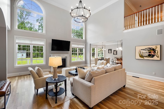3324 Greenhurst Dr, Weddington, NC 28104 - living room with a chandelier, baseboards, a fireplace, plenty of natural light, and ornamental molding