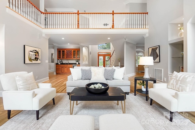 3324 Greenhurst Dr, Weddington, NC 28104 - living room featuring light wood-style flooring, a towering ceiling, baseboards, ornamental molding, and recessed lighting