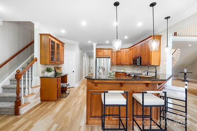 3324 Greenhurst Dr, Weddington, NC 28104 - kitchen with stainless steel appliances, brown cabinets, a peninsula, ornamental molding, and baseboards