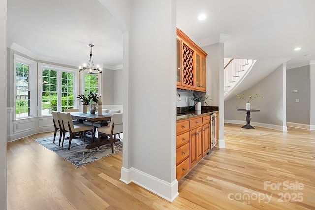 3324 Greenhurst Dr, Weddington, NC 28104 - indoor bar featuring ornamental molding, light wood-style flooring, baseboards, recessed lighting, and arched walkways