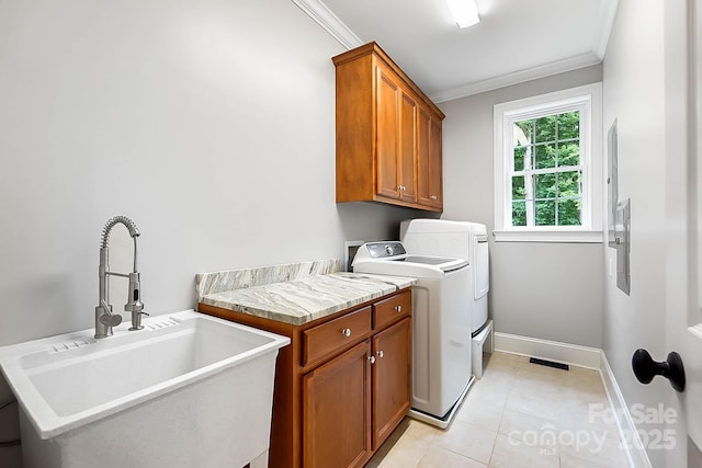 3324 Greenhurst Dr, Weddington, NC 28104 - washroom featuring cabinet space, ornamental molding, washer and dryer, light tile patterned floors, and baseboards