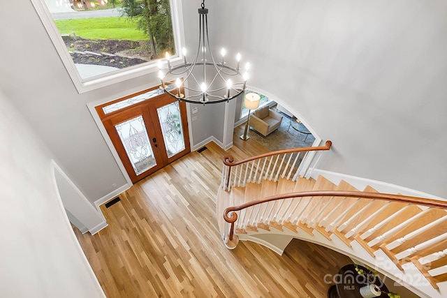 3324 Greenhurst Dr, Weddington, NC 28104 - foyer with a chandelier, wood finished floors, a towering ceiling, baseboards, and french doors