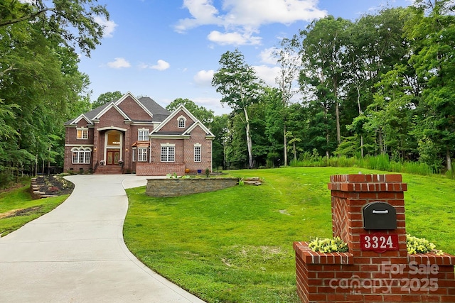 3324 Greenhurst Dr, Weddington, NC 28104 - view of front of house with brick siding, a front yard, and driveway