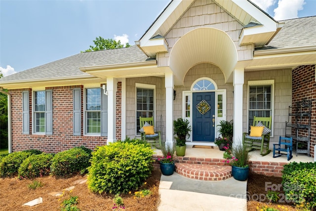 133 Upland Dr, Statesville, NC 28625 - doorway to property with a shingled roof, covered porch, and brick siding