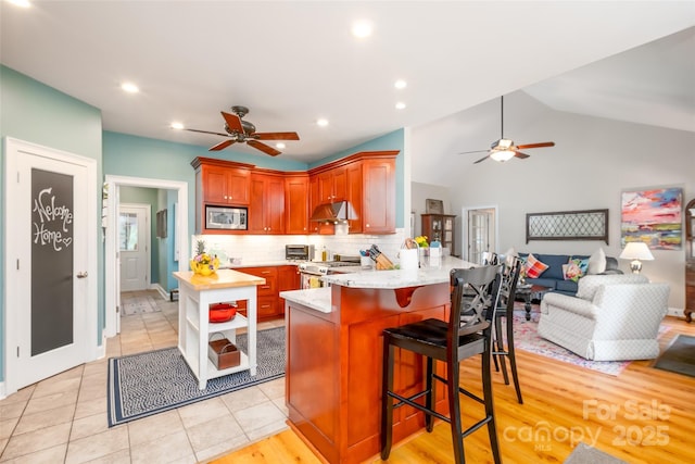 133 Upland Dr, Statesville, NC 28625 - kitchen with appliances with stainless steel finishes, ceiling fan, under cabinet range hood, a peninsula, and recessed lighting