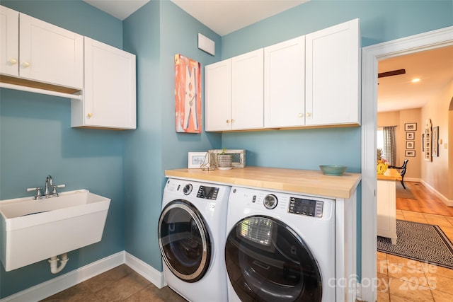133 Upland Dr, Statesville, NC 28625 - laundry room featuring separate washer and dryer, cabinet space, baseboards, and tile patterned flooring