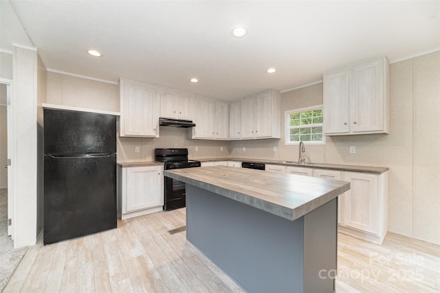 5090 Beaver Dam Way, Bessemer City, NC 28016 - kitchen with black appliances, wood counters, under cabinet range hood, light wood finished floors, and crown molding