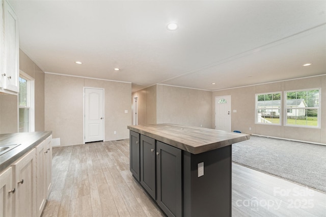 5090 Beaver Dam Way, Bessemer City, NC 28016 - kitchen featuring butcher block counters, light wood finished floors, plenty of natural light, open floor plan, and ornamental molding