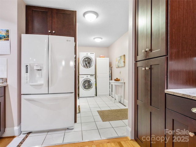 138 Down To Earth Dr, Burnsville, NC 28714 - laundry area featuring estacked washer and dryer, baseboards, and light tile patterned floors