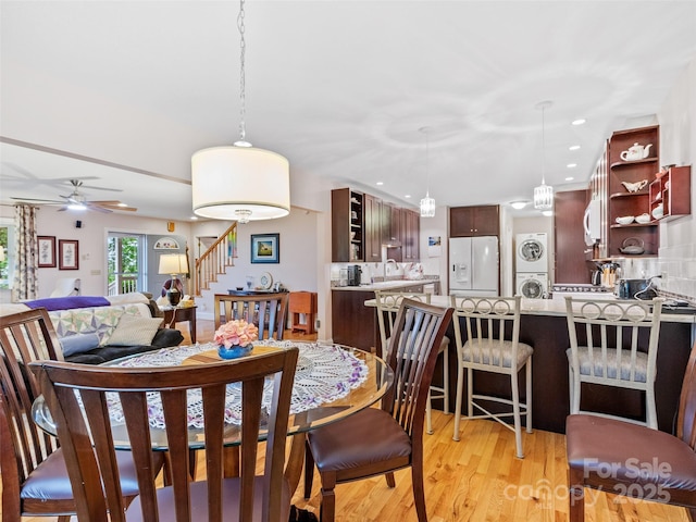 138 Down To Earth Dr, Burnsville, NC 28714 - dining space with stacked washer and clothes dryer, stairway, light wood-style flooring, a ceiling fan, and recessed lighting