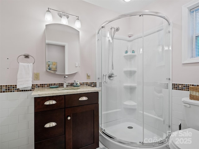 138 Down To Earth Dr, Burnsville, NC 28714 - full bathroom with tile walls, a shower stall, toilet, vanity, and wainscoting