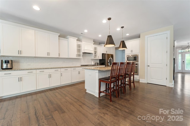 1906 Pensco Pond Ct, Waxhaw, NC 28173 - kitchen with stainless steel appliances, backsplash, dark wood-style floors, white cabinetry, and recessed lighting