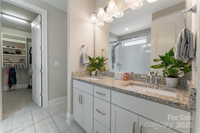 1906 Pensco Pond Ct, Waxhaw, NC 28173 - bathroom with a shower stall, double vanity, and a walk in closet