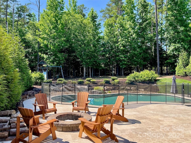 1906 Pensco Pond Ct, Waxhaw, NC 28173 - view of pool featuring a fire pit, a patio area, and view of wooded area