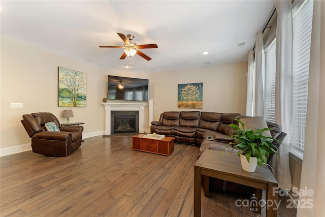 1906 Pensco Pond Ct, Waxhaw, NC 28173 - living room featuring wood finished floors, a ceiling fan, recessed lighting, and a glass covered fireplace