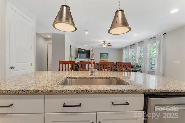 1906 Pensco Pond Ct, Waxhaw, NC 28173 - kitchen with stainless steel dishwasher, ceiling fan, light stone countertops, recessed lighting, and open floor plan