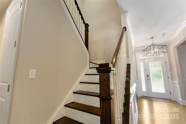1906 Pensco Pond Ct, Waxhaw, NC 28173 - staircase with a chandelier, wood finished floors, and ornamental molding