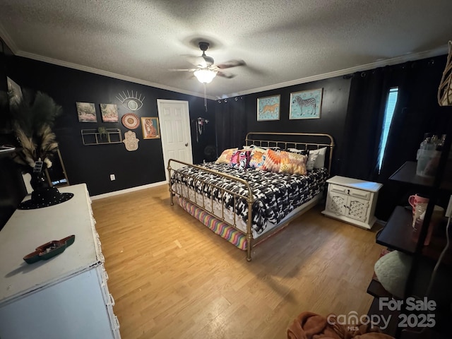 13211 Asbury Chapel Rd, Huntersville, NC 28078 - bedroom with crown molding, wood finished floors, a textured ceiling, baseboards, and a ceiling fan