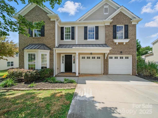 8304 Prescott Glen Pkwy, Waxhaw, NC 28173 - view of front of house with driveway, brick siding, a garage, and a standing seam roof