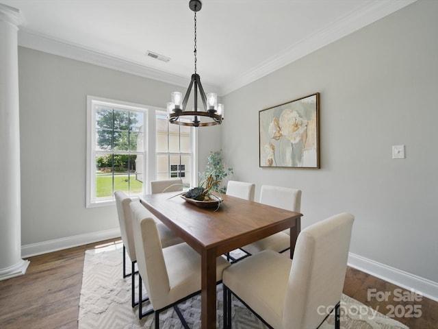 8304 Prescott Glen Pkwy, Waxhaw, NC 28173 - dining room with ornate columns, a chandelier, baseboards, crown molding, and wood finished floors