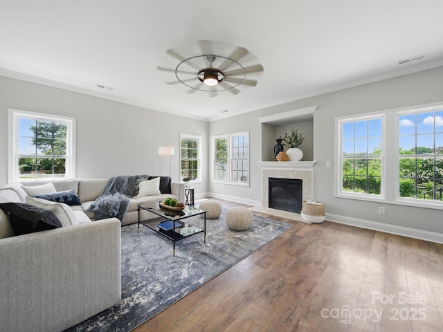 8304 Prescott Glen Pkwy, Waxhaw, NC 28173 - living room featuring healthy amount of natural light, baseboards, crown molding, wood finished floors, and a premium fireplace