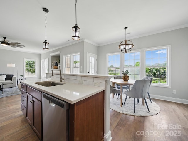 8304 Prescott Glen Pkwy, Waxhaw, NC 28173 - kitchen featuring stainless steel dishwasher, a sink, light countertops, open floor plan, and dark wood finished floors