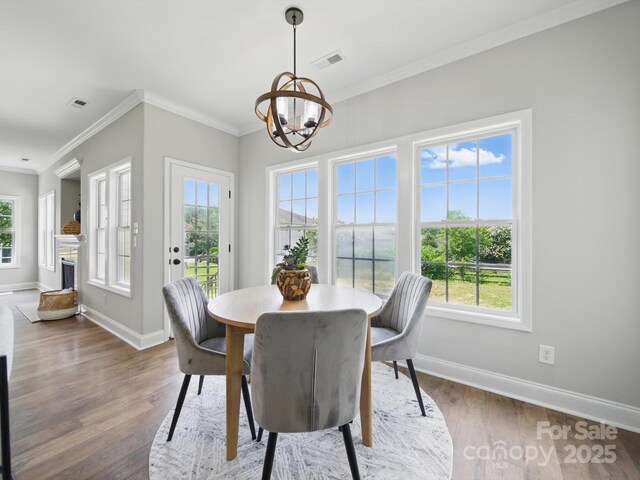 8304 Prescott Glen Pkwy, Waxhaw, NC 28173 - dining space featuring baseboards, a chandelier, wood finished floors, and crown molding