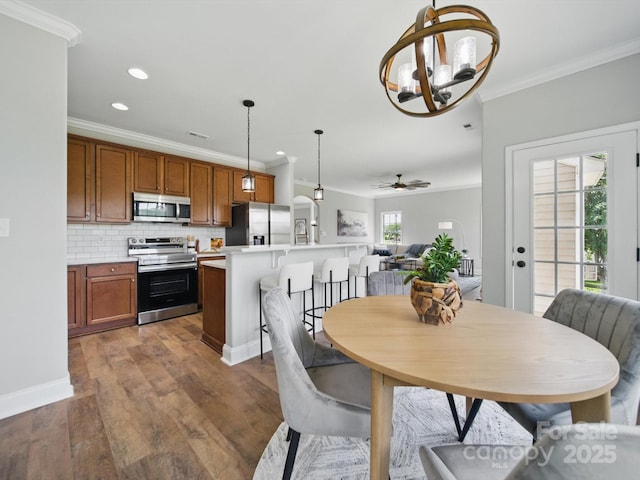 8304 Prescott Glen Pkwy, Waxhaw, NC 28173 - dining space with crown molding, recessed lighting, wood finished floors, a chandelier, and a ceiling fan