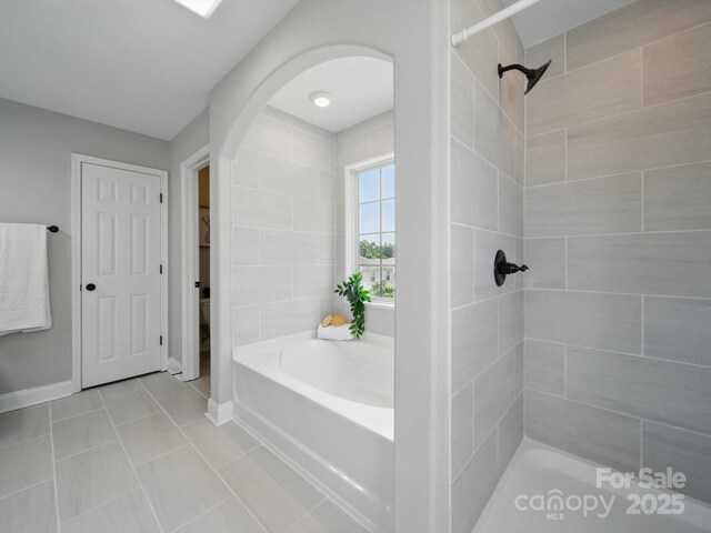 8304 Prescott Glen Pkwy, Waxhaw, NC 28173 - bathroom with a bath, tile patterned floors, a tile shower, and baseboards