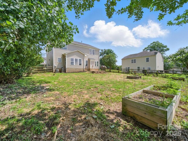 8304 Prescott Glen Pkwy, Waxhaw, NC 28173 - rear view of property with a garden and central AC