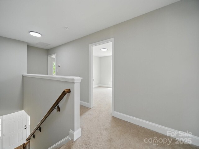 8304 Prescott Glen Pkwy, Waxhaw, NC 28173 - hall with an upstairs landing, light colored carpet, and baseboards
