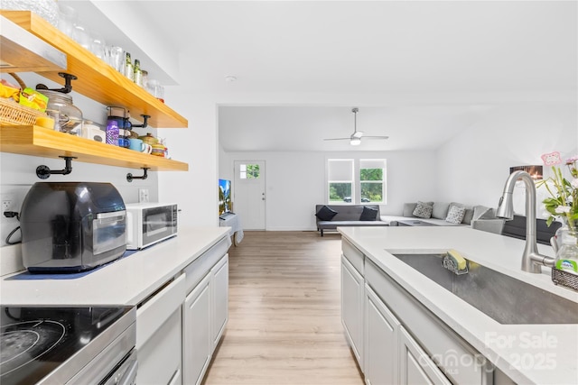 221 Reliance Rd, Kings Mountain, NC 28086 - kitchen with a sink, light wood-type flooring, light countertops, a ceiling fan, and open floor plan
