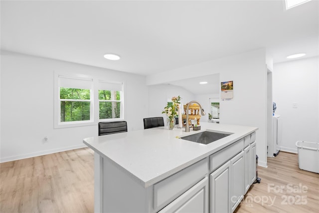 221 Reliance Rd, Kings Mountain, NC 28086 - kitchen featuring a sink, light wood finished floors, light countertops, a center island with sink, and baseboards
