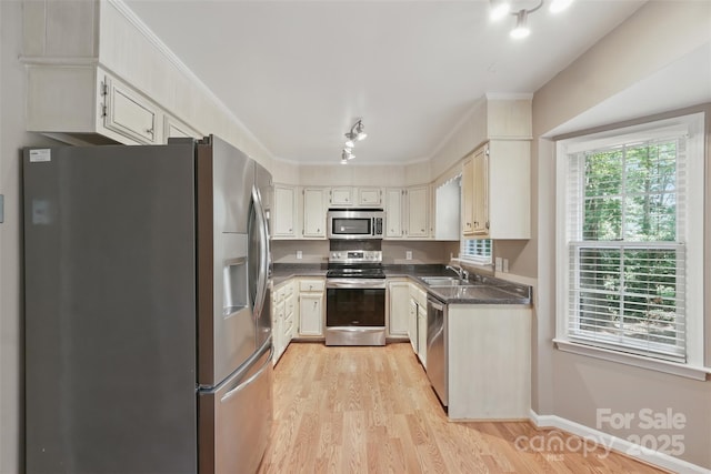 1517 E Barden Rd, Charlotte, NC 28226 - kitchen with appliances with stainless steel finishes, light wood finished floors, dark countertops, and ornamental molding