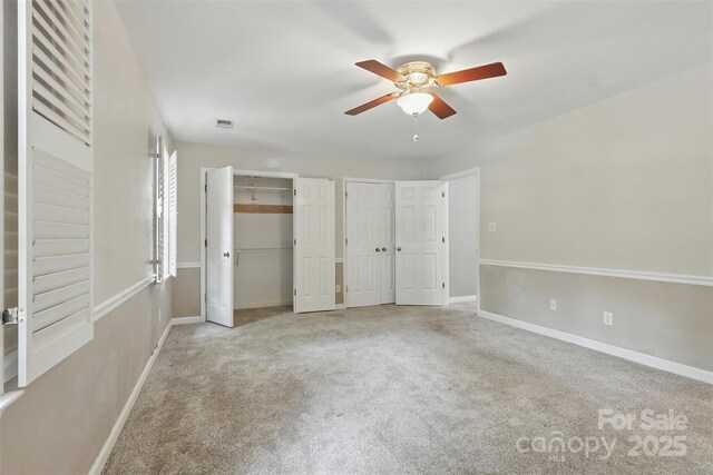 1517 E Barden Rd, Charlotte, NC 28226 - unfurnished bedroom with multiple closets, carpet flooring, and a ceiling fan