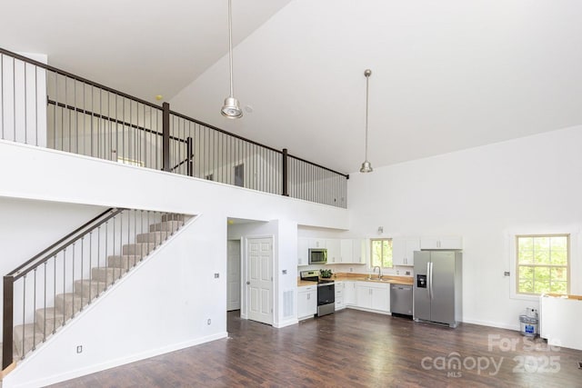 109 Tumblebug Trail Rd, Flat Rock, NC 28731 - unfurnished living room with a high ceiling, dark wood-type flooring, and stairs