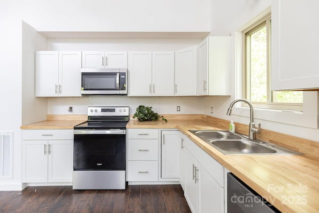 109 Tumblebug Trail Rd, Flat Rock, NC 28731 - kitchen featuring stainless steel appliances, white cabinetry, dark wood finished floors, and wooden counters