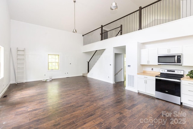 109 Tumblebug Trail Rd, Flat Rock, NC 28731 - kitchen with appliances with stainless steel finishes, a high ceiling, dark wood finished floors, white cabinetry, and light countertops