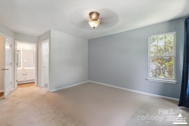 6516 Laurel Springs Ct, Charlotte, NC 28227 - unfurnished bedroom featuring light carpet, baseboards, ensuite bathroom, and a ceiling fan