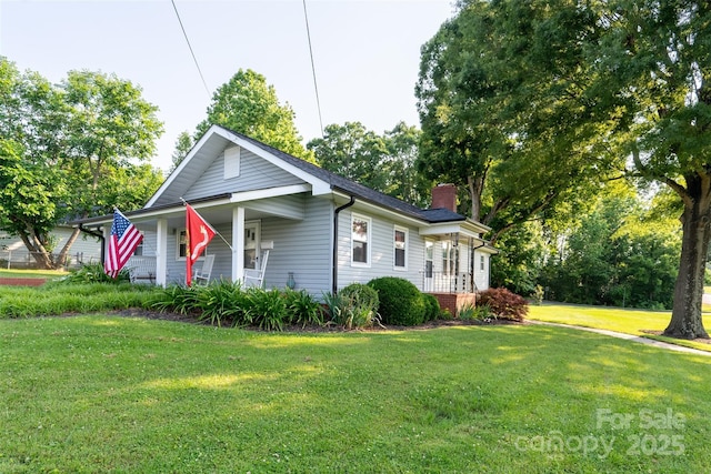 100 S Rudisill Ave, Cherryville, NC 28021 - view of front facade with a chimney, a front lawn, and a porch