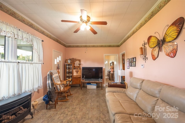 100 S Rudisill Ave, Cherryville, NC 28021 - living room with ceiling fan, heating unit, ornamental molding, and a wood stove